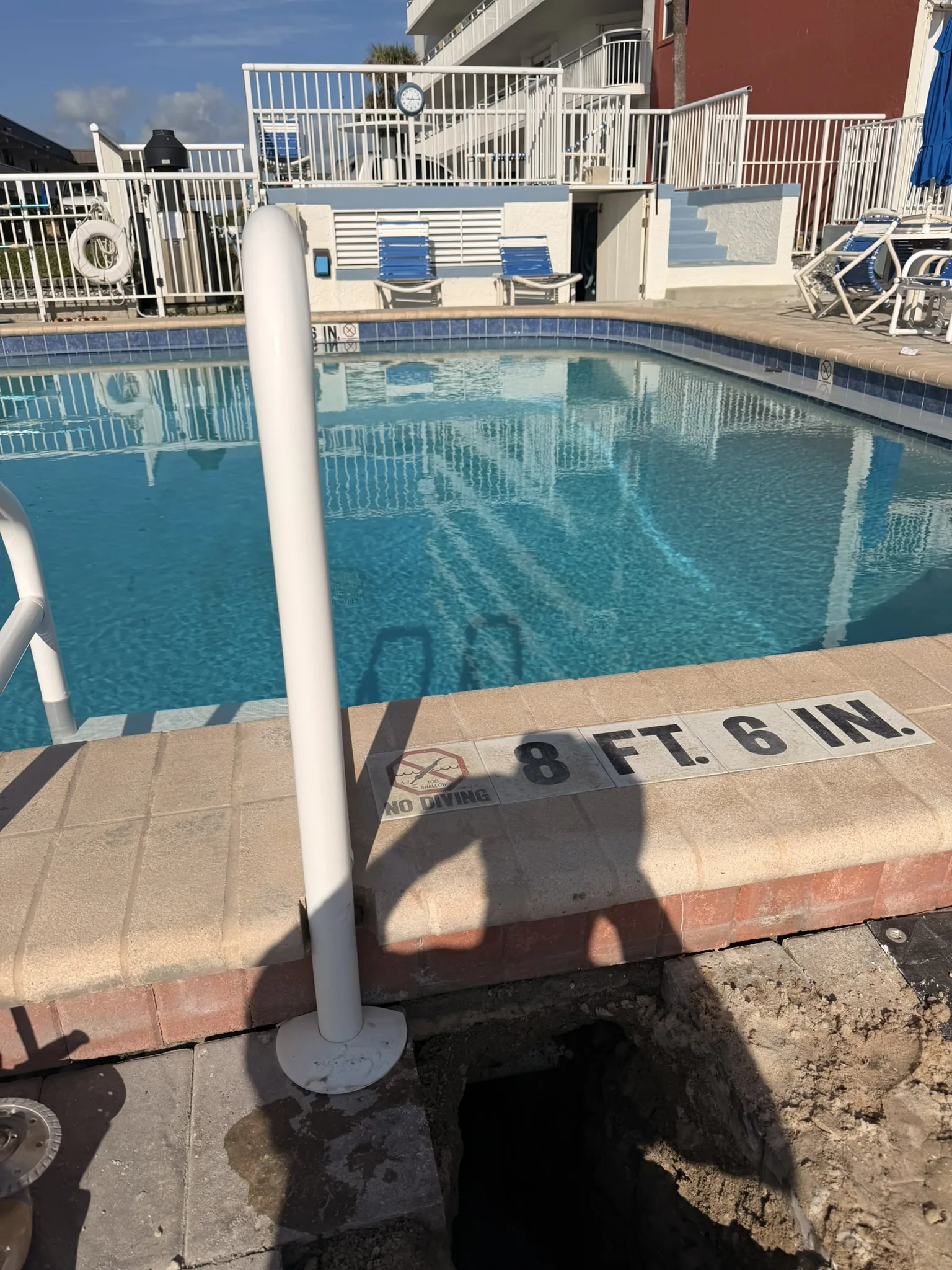 Commercial beachfront pool with the deck opened at the corner to reach a return-line leak — Daytona Beach Shores, FL