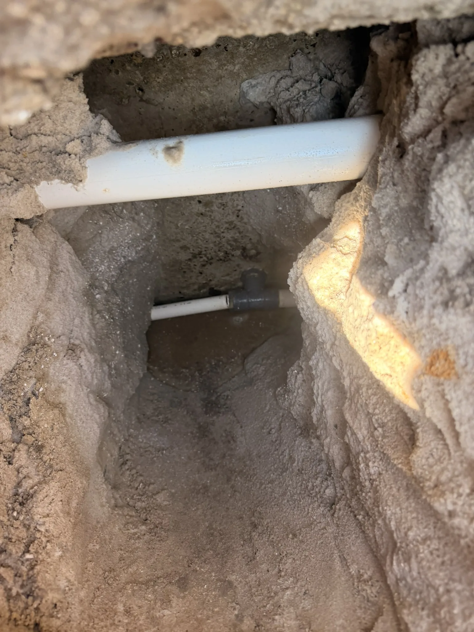 Pool return-line plumbing exposed in the excavation — Daytona Beach Shores, FL