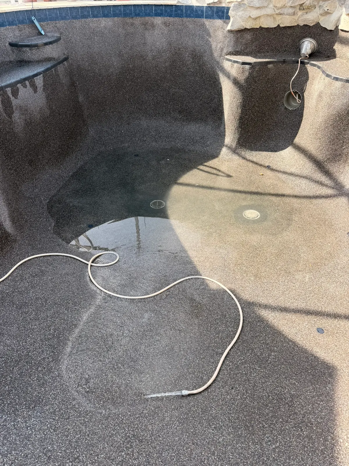 Both main drains reset and patched flush into the pebble floor of a drained pool &mdash; Palm Coast, FL