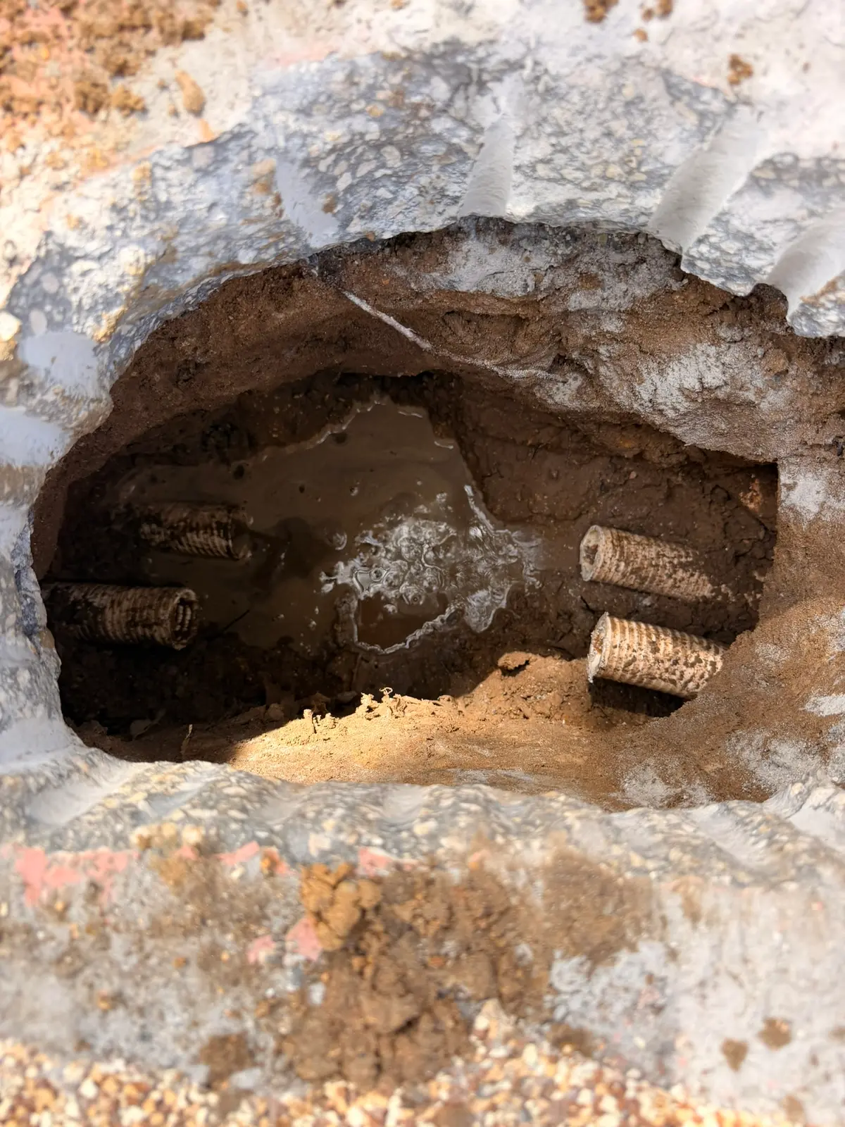 Excavation with the failed therapy jet fitting cut out and groundwater seeping in — New Smyrna Beach, FL