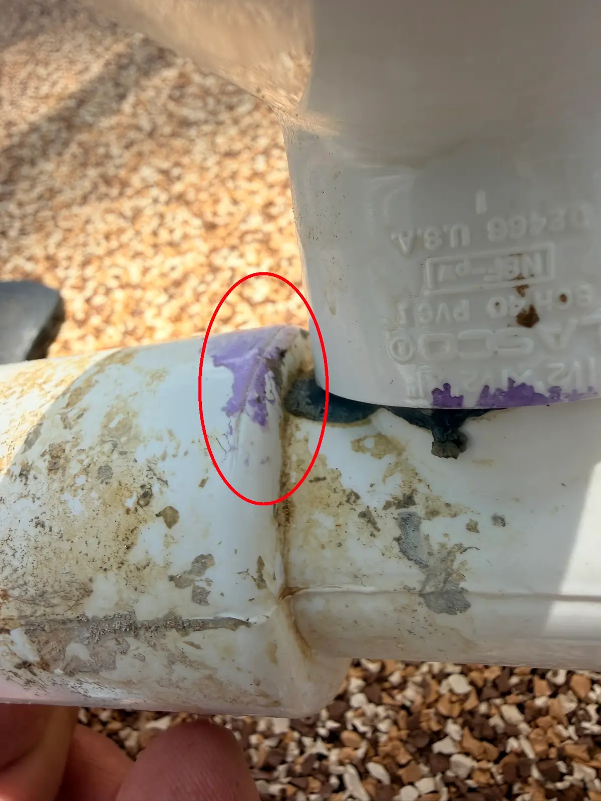 Close-up of a hairline crack running out of the glue joint on the venturi fitting — New Smyrna Beach, FL