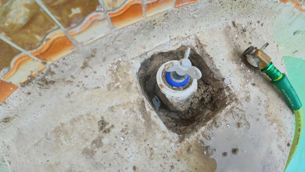 Plaster cut away and the pool shell demoed to expose a floor jet fitting — Ormond Beach, FL