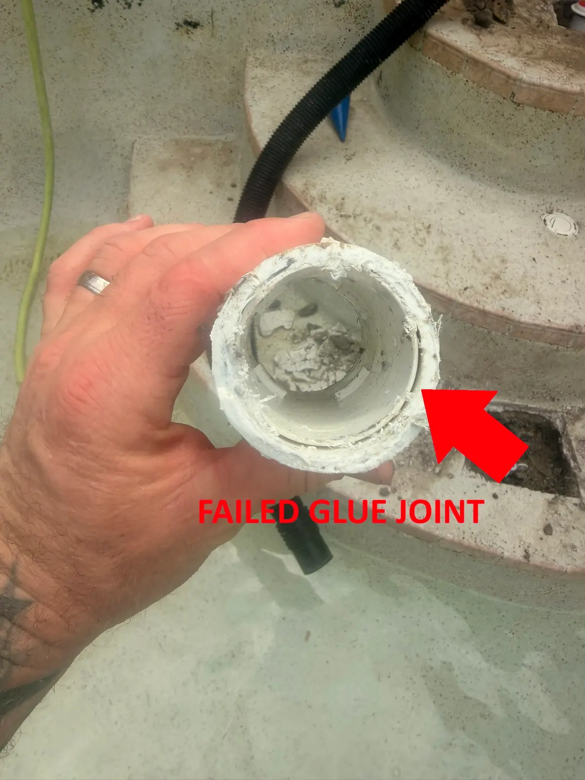 Close-up of a cut-out floor jet fitting showing a glue joint that never fully bonded — Ormond Beach, FL