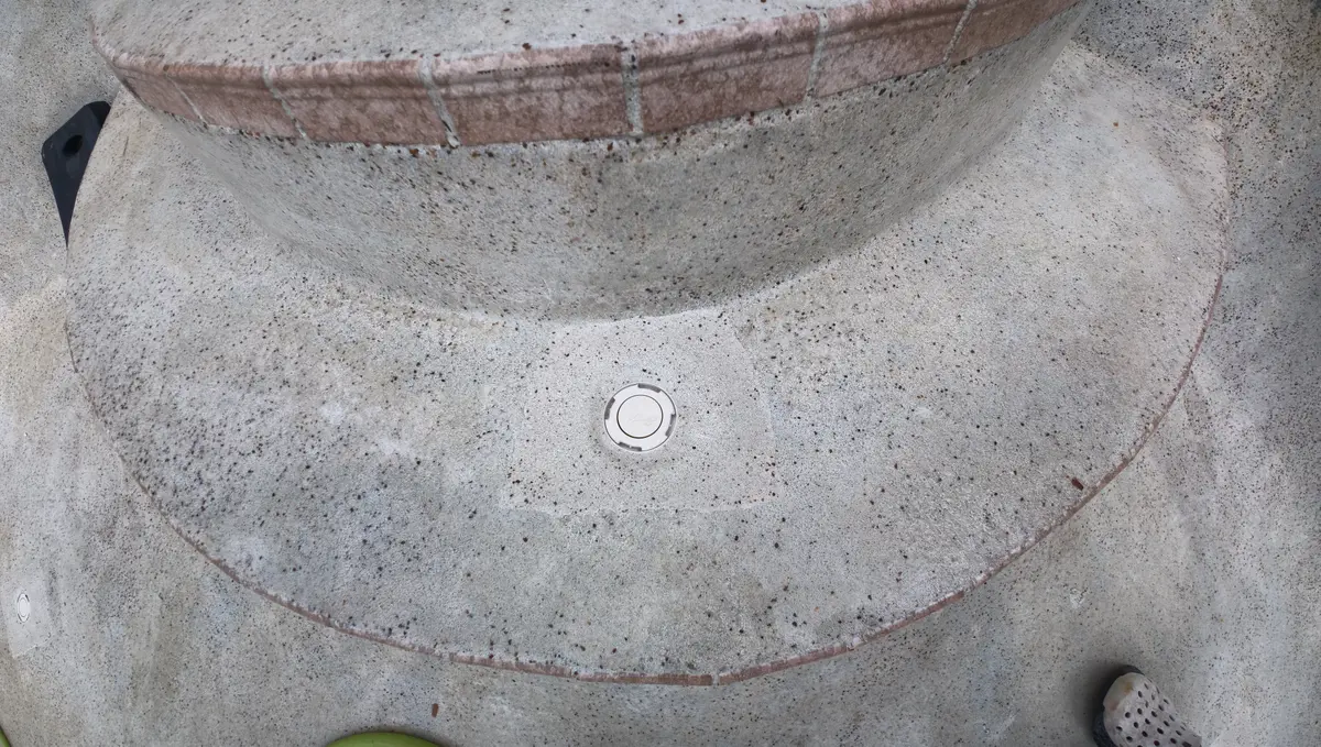 Finished floor jet sitting flush in freshly patched pool plaster — Ormond Beach, FL