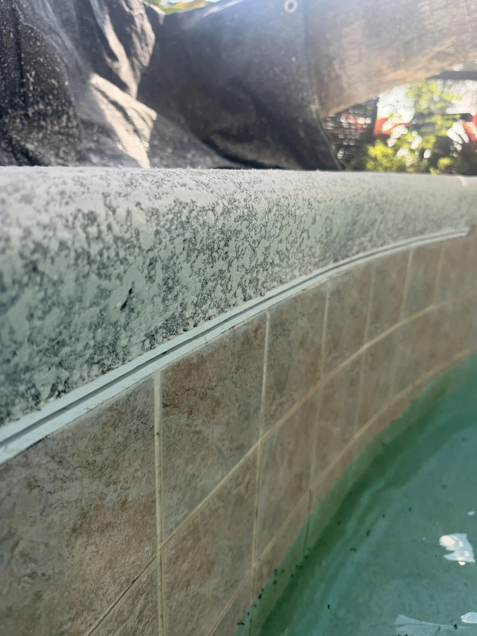 Clean coping-to-tile joint on the restored waterfall beam — Palm Coast, FL