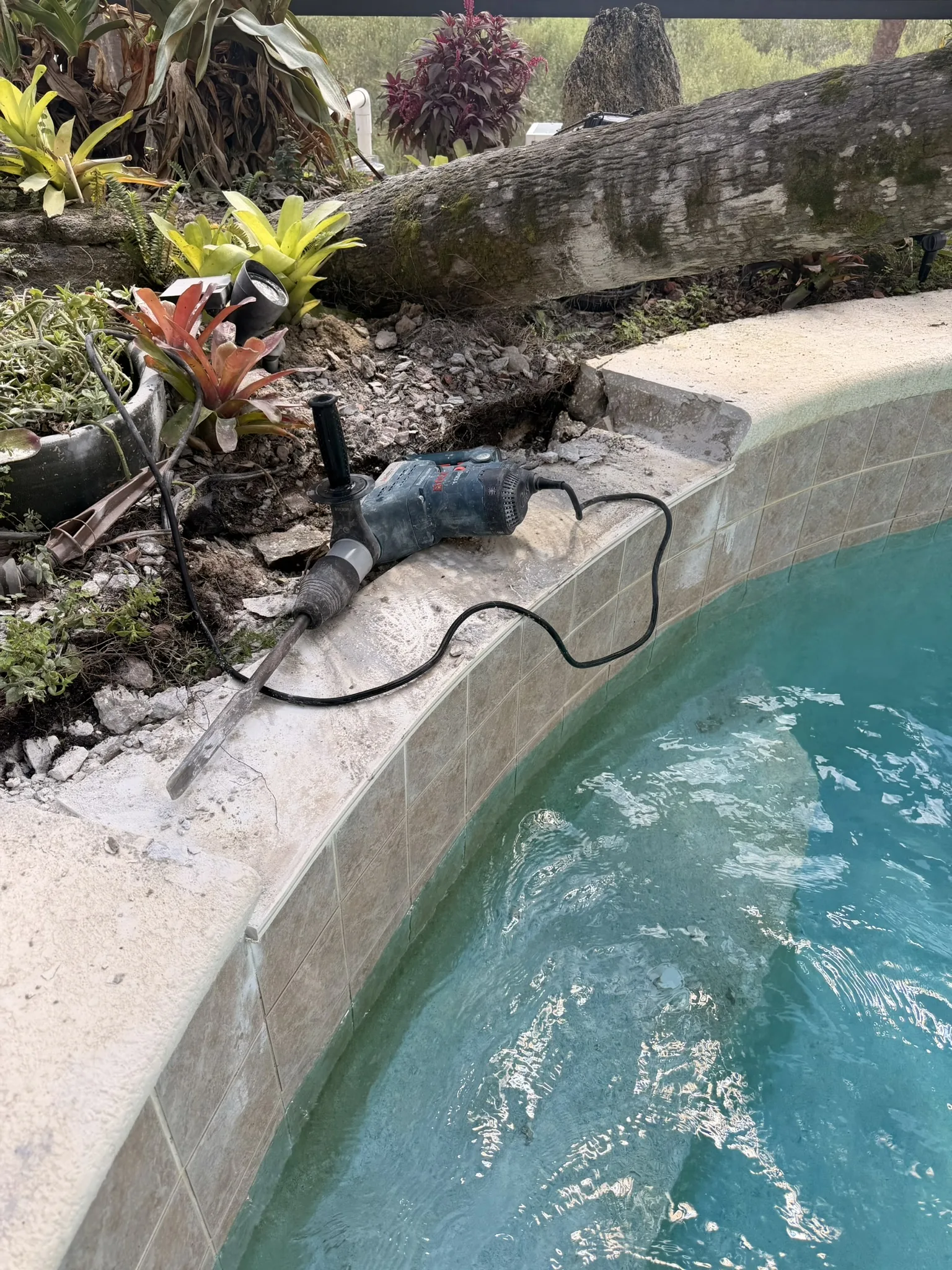 Concrete beam chipped open to reach the failed waterfall fixture — Palm Coast, FL